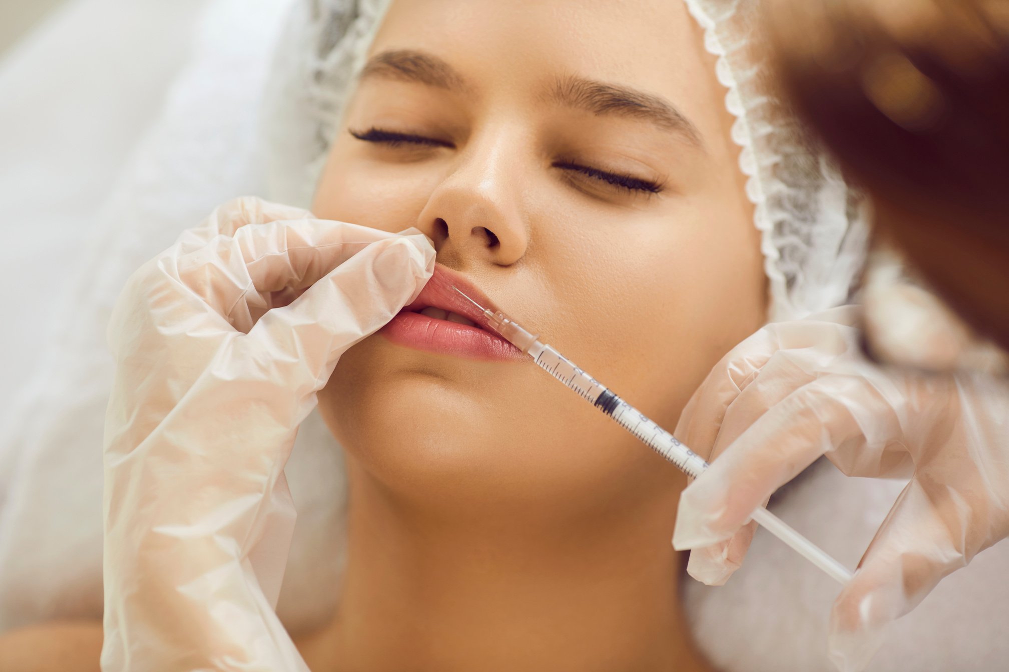 Young Girl Getting Botox Injection for Bigger Lips at Clinic of Aesthetic Medicine